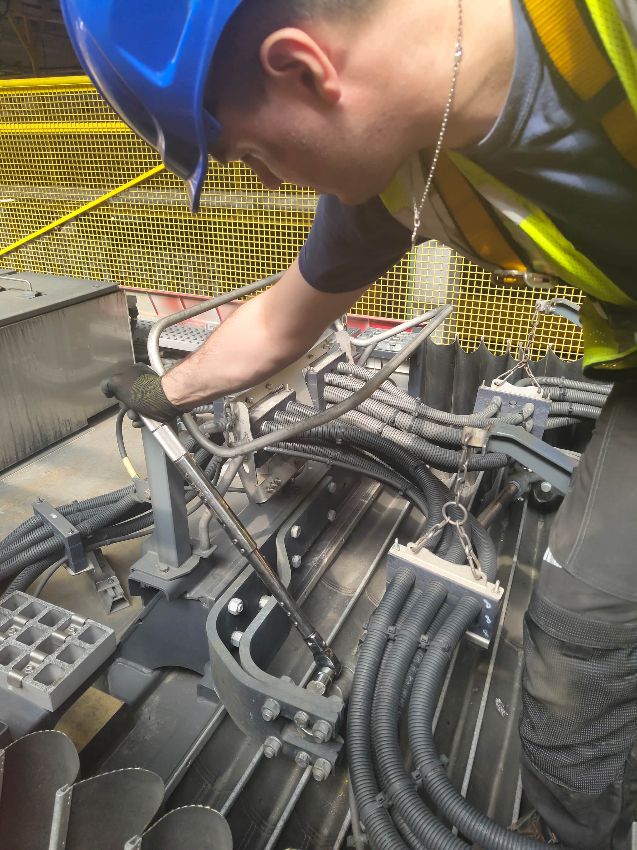 Technician servicing tram roof equipment in progress — Warsaw depot